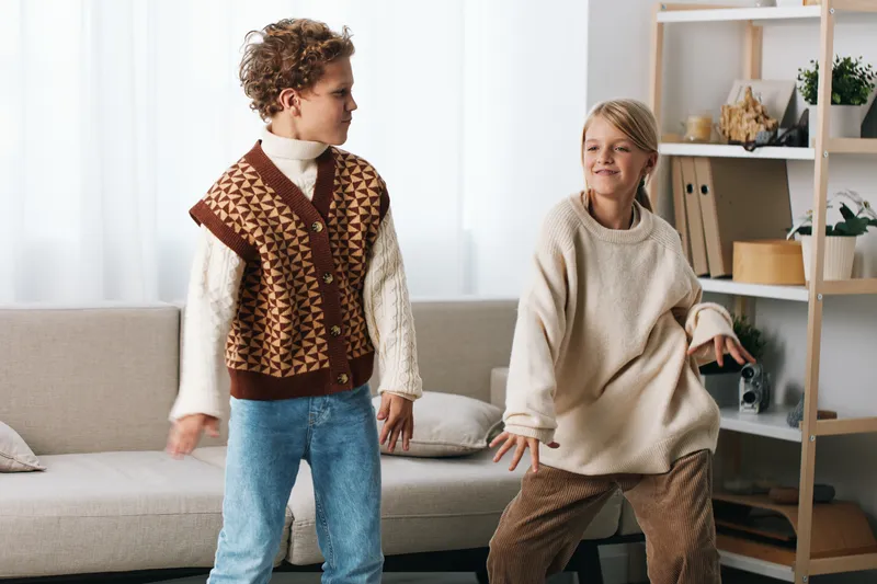 Authentic scene featuring children at play indoors, illustrating school themed lifestyle with candid movement and joyful interaction in a cozy home setting.