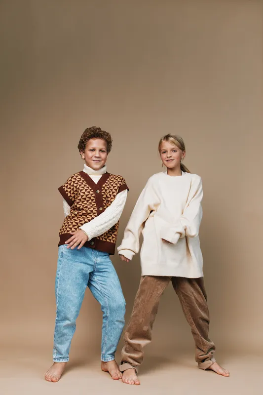 Authentic play scene featuring children in casual school age attire, capturing genuine movement, bright smiles, and a relaxed lifestyle focus.
