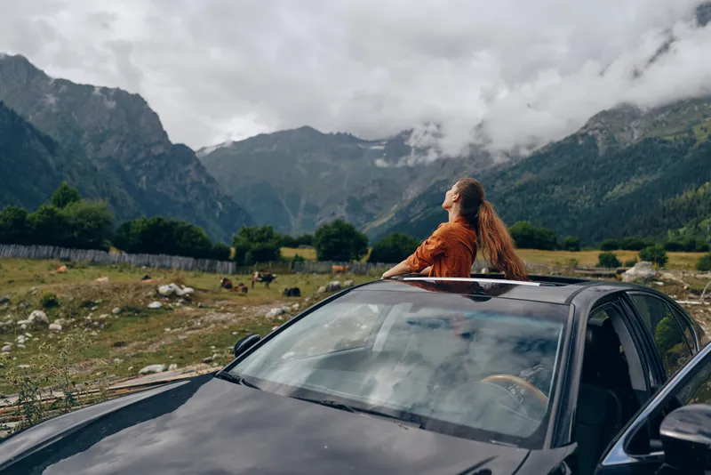 Woman car mountains nature travel freedom, authenticity inclusivity