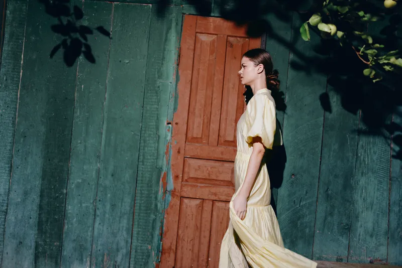 Woman dress walking profile by door wall with authenticity inclusivity