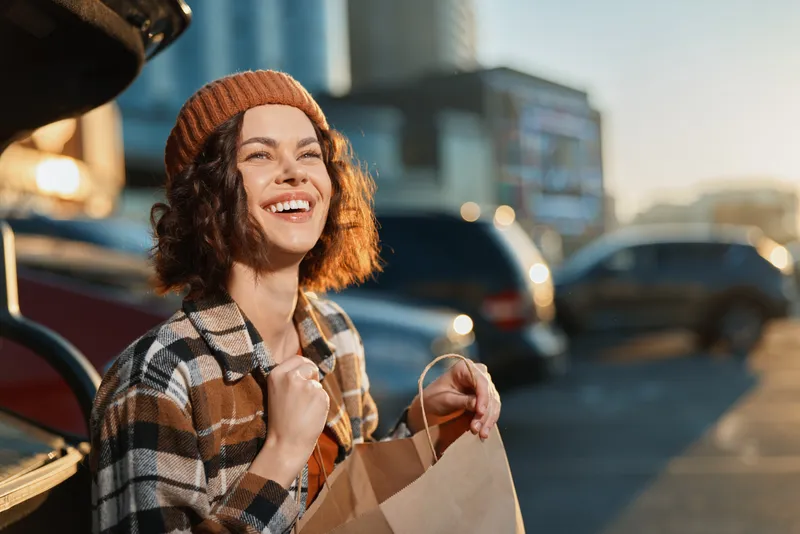 Woman smile shopping urban moment at golden hour, candid lifestyle portrait showing authenticity and emotional storytelling with golden hour glow, mindful living and joyful relaxed energy