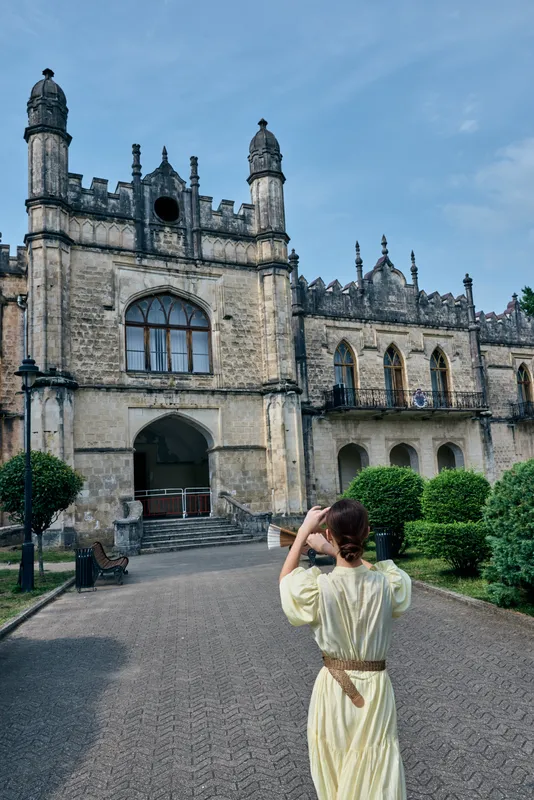 Woman historic architecture mansion, courtyard scene, authenticity inclusivity
