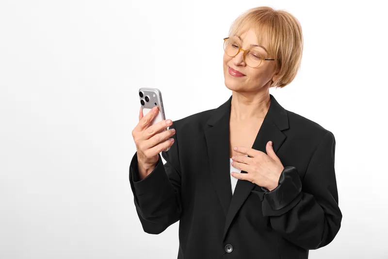 Woman smartphone business glasses senior communication smile portrait, businesswoman in suit holds phone and smiles, glasses visible, isolated on white