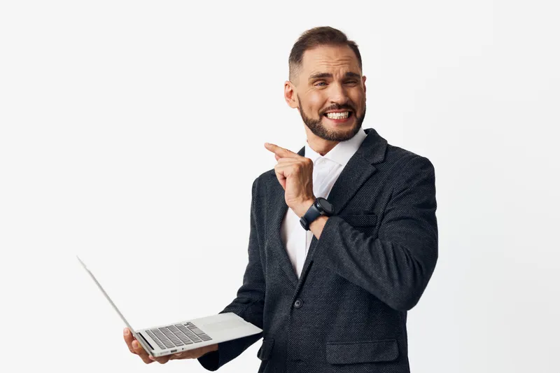Business portrait of a confident man in a smart jacket, displaying a cheerful expression and pointed gesture, isolated white background, conveying a professional, energetic vibe.