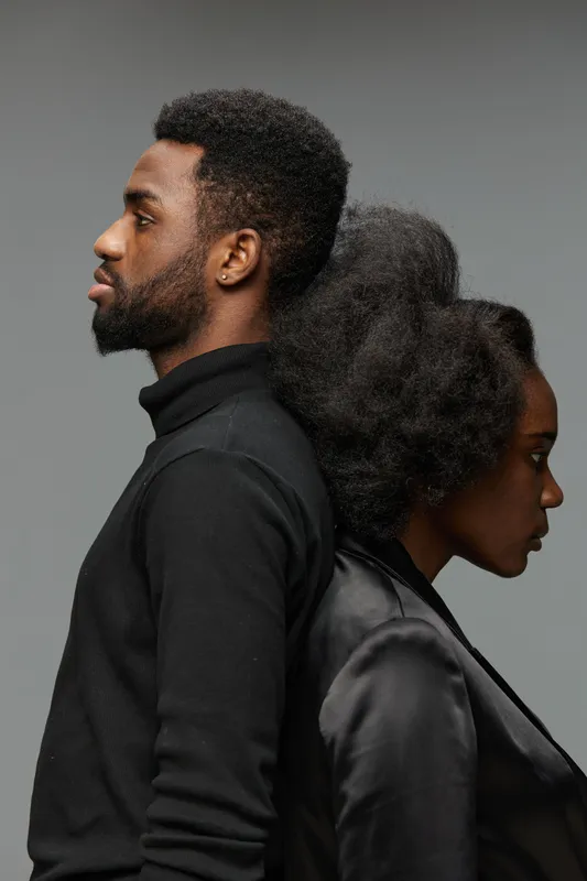 A striking black and white portrait of a male and female model, showcasing strong emotions and contrasting styles through their poses and expressions, ideal for emotional storytelling