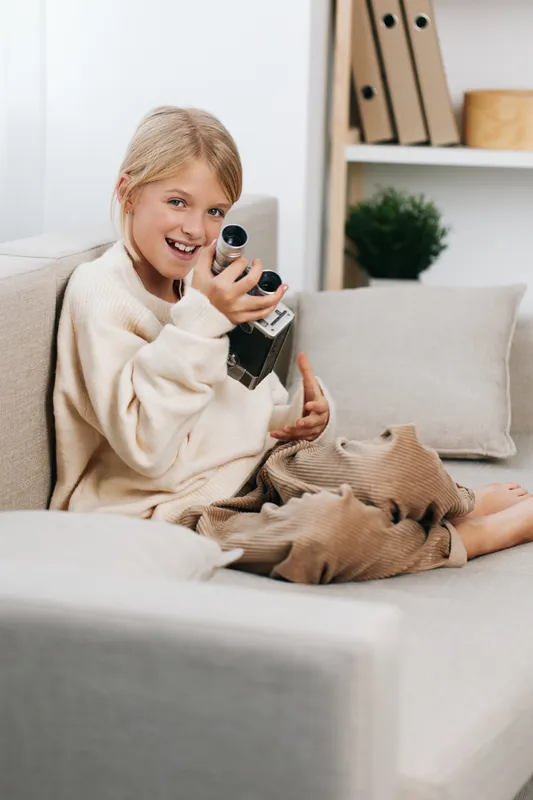 Authentic scene of a young student at home, exploring play and creativity with a toy microphone, balancing school life and casual learning in a cozy setting.