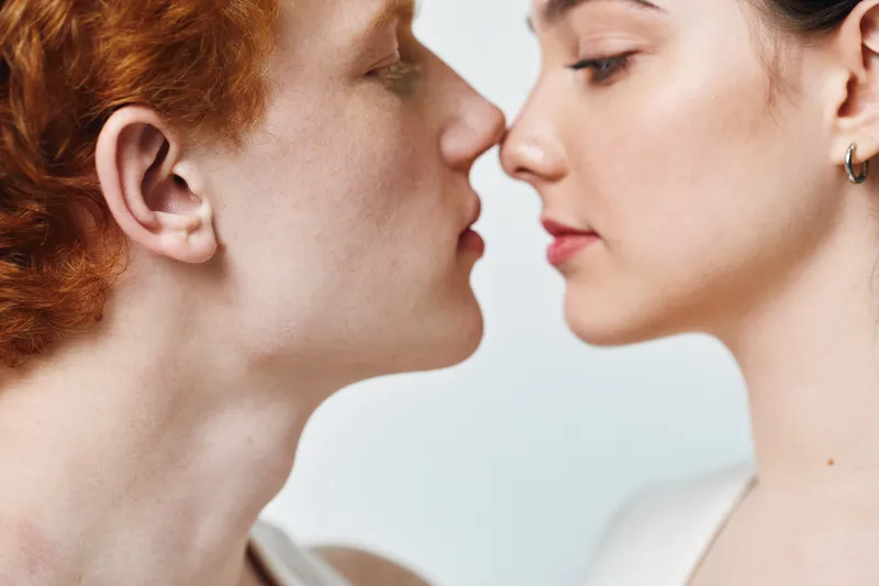 Couple, young man and woman in close face to face pose with light skin and red hair for intimacy, connection and romance portrait in studio. Emotion, love and relationship.