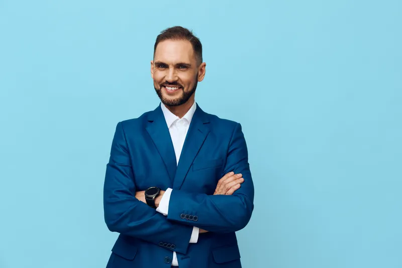 A confident business professional stands against a vibrant colored backdrop, exuding calm energy, approachable charm, and focused determination suitable for corporate branding.