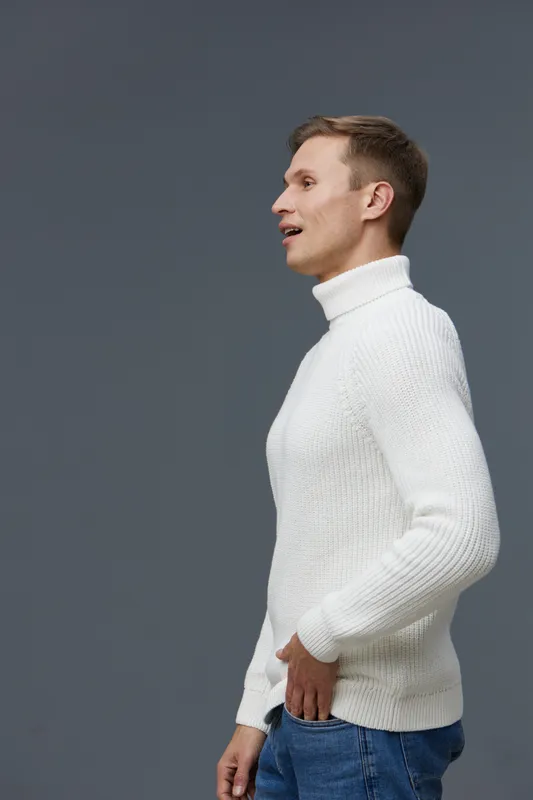 smiling man wearing white turtleneck casual sweater standing profile side view isolated on gray background digital nomad concept technology modern lifestyle communication cheerful young man