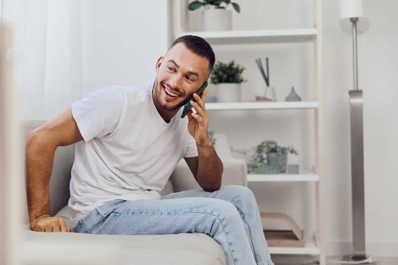 Joyful man engaged in an emotional phone call, highlighting the importance of authentic connection amidst modern technology. A moment of vulnerability and sincerity.