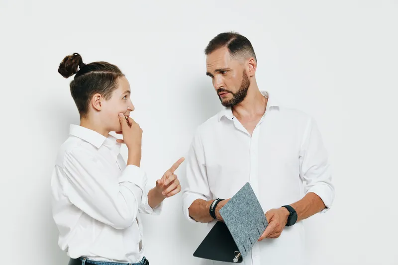 A professional male colleague engages in a focused discussion against an isolated white background, signaling business dialogue, leadership, and shared insight.