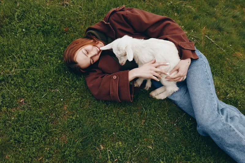 Goat, kid, girl, outdoor, grass, relaxing, affection, sunny, breeze, natural, colors, candid, moment, gentle, touch, playful, mood, close, bond, tranquil, scenery, nature, lifestyle, calm, atmosphere