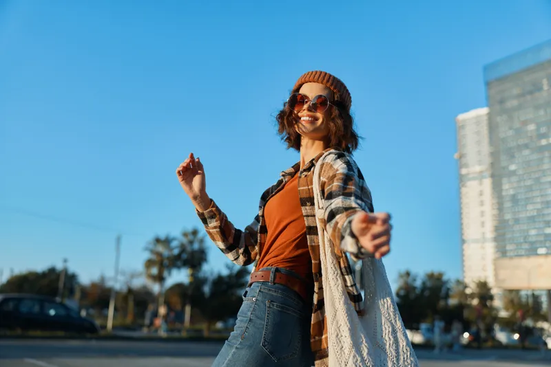 woman smiling in candid urban portrait at golden hour, joyful energy and carefree mood. Authenticity and candid lifestyle captured with golden hour glow, mindful living and emotional storytelling