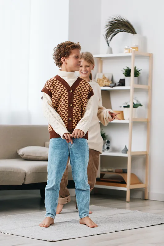 Authentic scene of children at play in a cozy home, two kids dressed for school themed pretend work, candid moment, warm light, simple joy, lifestyle moment.