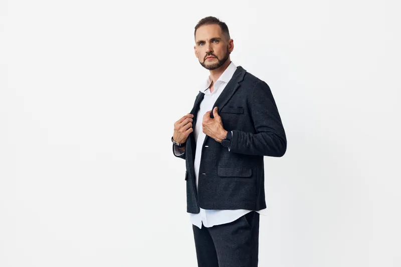 A professional man exudes confidence on an isolated colorful background, displaying controlled emotion and poised presence suitable for business, leadership, and corporate profiles.