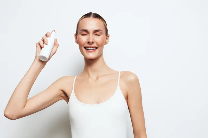 Woman, skincare, beauty, smiling, cream, facial, serum, hygiene, isolated, white, applying lotion with finger, holding drop, youthful healthy skin, spa wellness routine