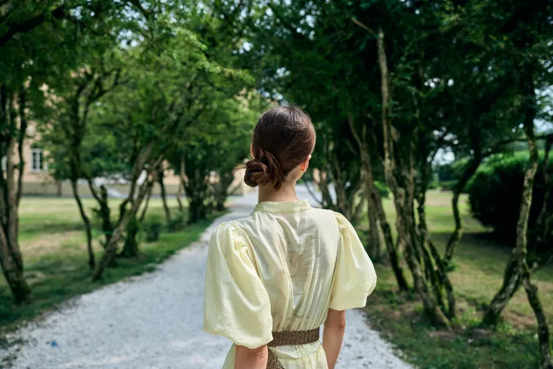 Woman dress walking back park pathway summer nature bun elegant authenticity inclusivity