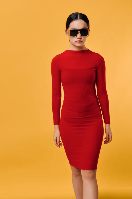 Woman in red dress and black sunglasses standing on yellow background for fashion style, elegance, confidence and modern beauty with minimalism and studio portrait concept.