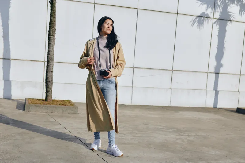 Fashion, woman, outdoor coat style in urban setting, casual denim ensemble, street scene with soft light and confident pose for a modern lifestyle mood