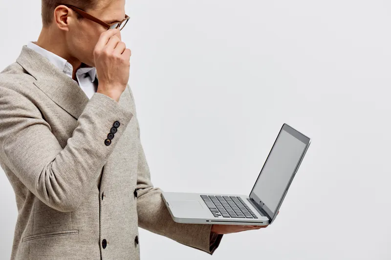 serious caucasian man holding laptop wear beige blazer eyeglasses look screen focus cybersecurity business concept isolated plain background