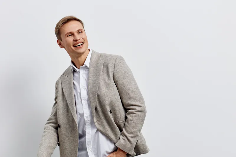 smiling young caucasian man wear casual jacket look aside happy cheerful emotion isolated on plain light background digital nomad remote work concept