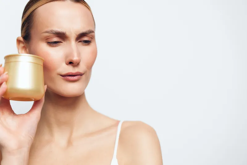 Woman holding cup, close up portrait with calm skincare and beauty routine, soft light, minimal background, bare shoulders, natural skin, wellness break, tea moment