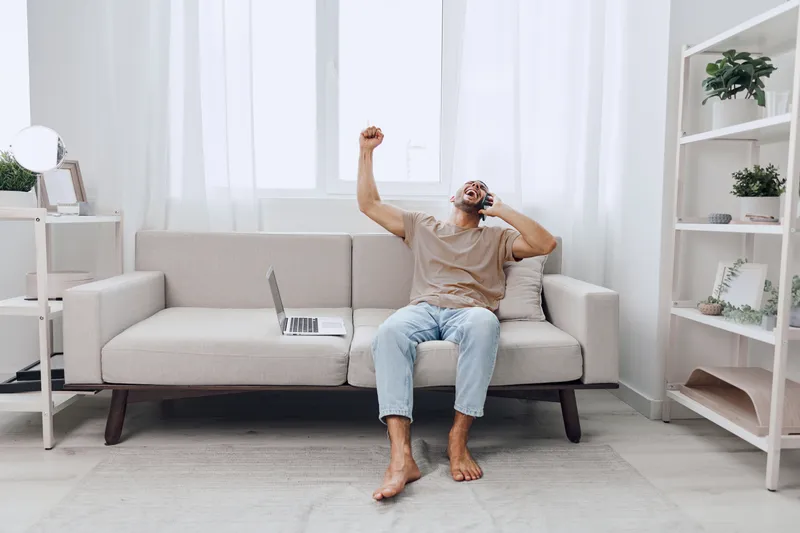 Relaxed man enjoying a moment of solitude, exploring digital detox in a cozy living space, embodying emotional minimalism and authentic imperfection.
