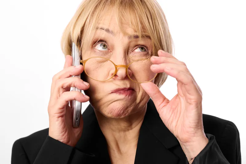 Elderly woman portrait glasses phone smartphone eyeglasses senior communication call, surprised expression, adjusting eyeglasses hands, closeup portrait on white background