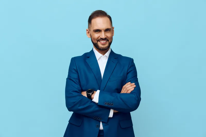 A professional business man stands confidently against an isolated colored backdrop, exuding optimism and focus. His composed expression conveys trust and leadership readiness.