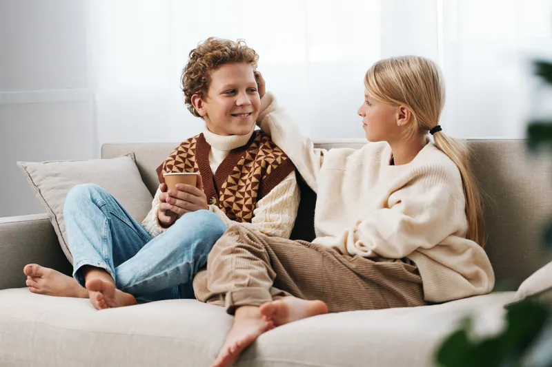 Authentic scene of siblings enjoying a cozy play moment at home, with a school inspired lifestyle, warm light, soft textures, candid mood, and everyday joy.