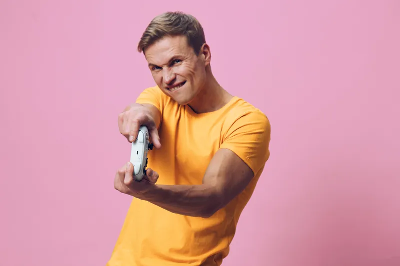 Full body enthusiastic smiling young caucasian man in bright yellow t-shirt taking selfie with smartphone on pink background studio portrait. People lifestyle concept
