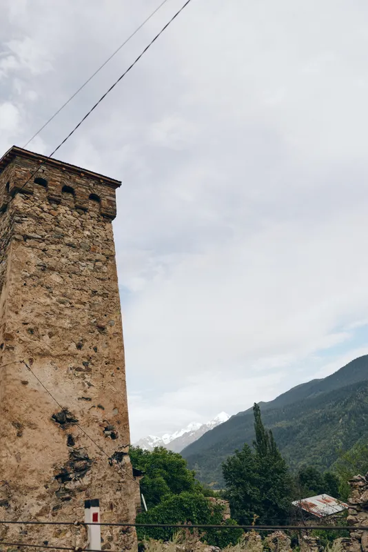 Tower mountain sky stone landscape rustic greenery clouds historic scene with authenticity inclusivity for travel views