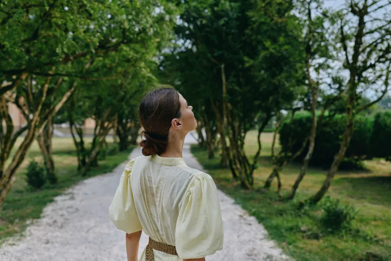 Woman walking on path in nature, authenticity and inclusivity in outdoor portrait