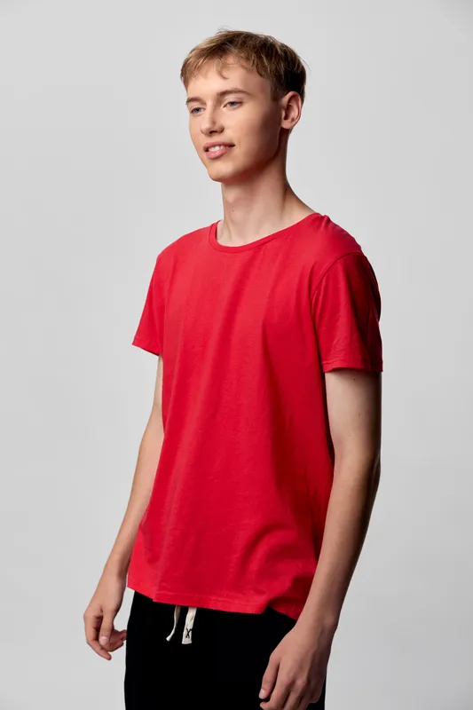 Young man, casual clothing, red tshirt, standing pose, neutral background, fashion and lifestyle imagery for apparel, daily wear, model styling, clean and modern presentation
