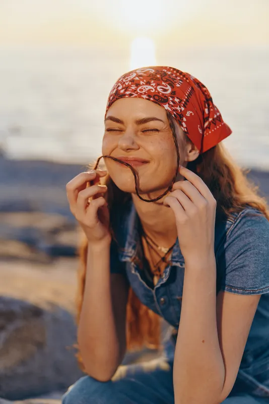 lifestyle woman in modern boho-western denim street style smiling outdoors at sunset with film color warmth and relaxed expression
