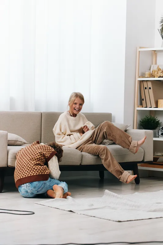 Authentic lifestyle moment showing a parent and child at home, embracing playful interaction, simple learning, cozy routines, and everyday school day vibes.