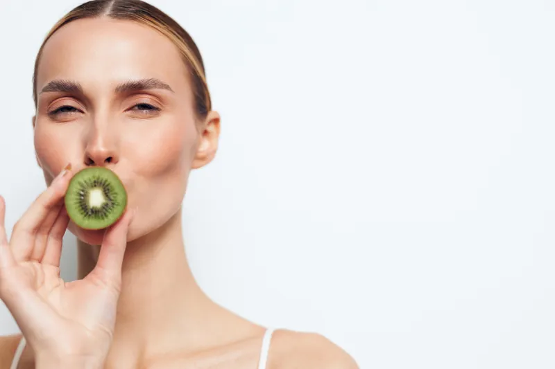 Woman kiwi skincare beauty wellness self care close up portrait on white background, soft studio lighting, fresh fruit glow for healthy facial routine