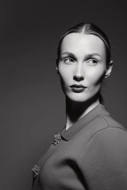Portrait of a Caucasian woman with light skin in vintage style looking sideways in black and white. Concept for classic beauty and retro fashion.