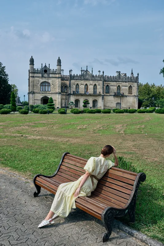 woman bench historic architecture park dress authenticity inclusivity