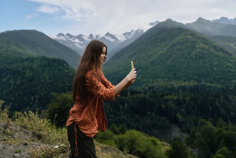 Authentic inclusive woman on mountains phone