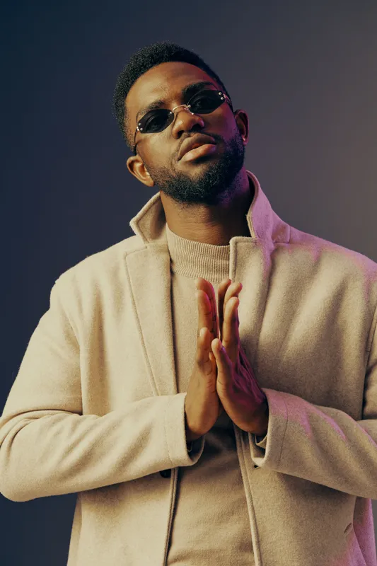 Stylish Black man in a modern outfit with sunglasses, showcasing confidence and elegance against a gradient background KEY elements include fashion, emotion, and modernity