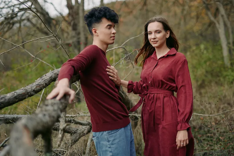 A candid portrait of a couple in natural surroundings, focusing on a genuine emotional connection and believable interaction that conveys trust and honest human intimacy, warm earthy tones.