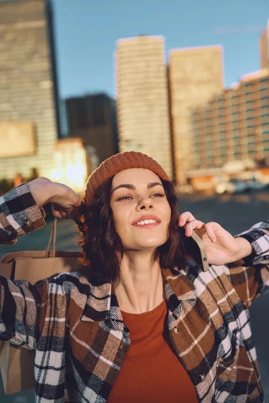 Woman smile urban city beanie candid lifestyle happiness captured in golden hour glow, authenticity and mindful living in emotional storytelling portrait of joyful modern street fashion and warmth.