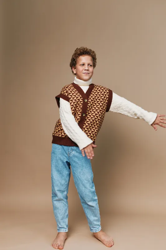 Authentic portrait of a young child in a playful pose, capturing a simple school life moment and a warm lifestyle through relaxed expression and light movement.