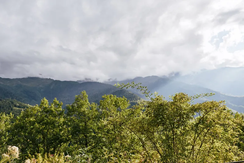 Mountain landscape with sky, clouds trees and forest