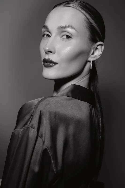 Portrait of a young Caucasian woman with light skin and sleek hair in monochrome. Elegant mood with soft lighting and classic style.