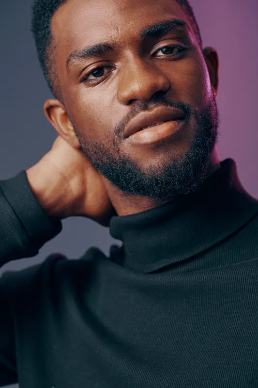 Confident young Black man in a black turtleneck against a purple gradient background, expressing a calm and relaxed emotion, ideal for lifestyle and fashion themes