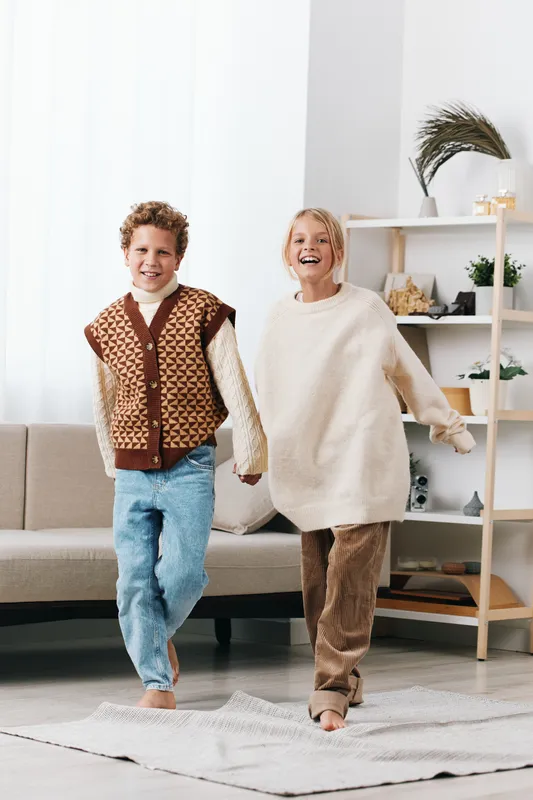 Authentic, playful scene features children in a cozy home as they enjoy school inspired play, highlighting lifestyle, warmth, and gentle movement in a candid moment.