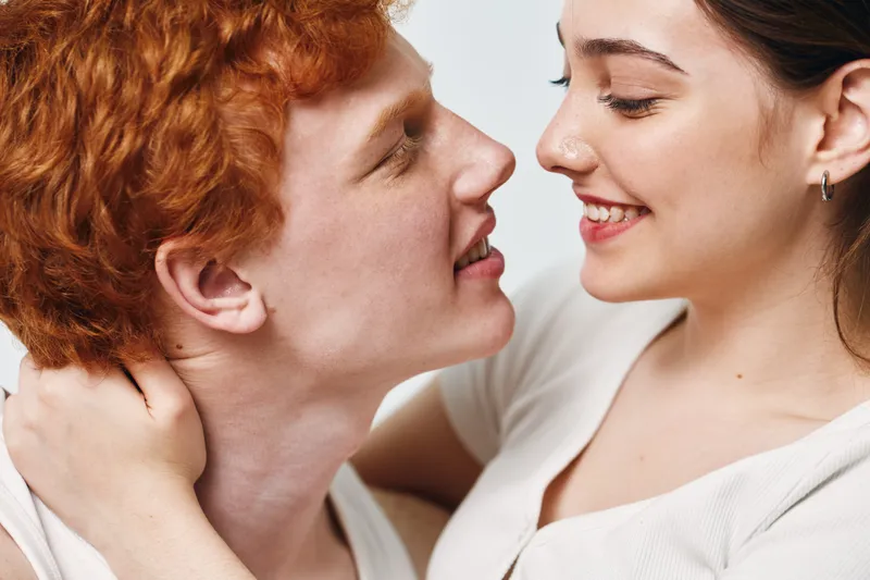 Couple, love, smile and intimacy with young man and woman closeup in tender romantic moment. Relationship, affection and happiness with close embrace and eye contact together.