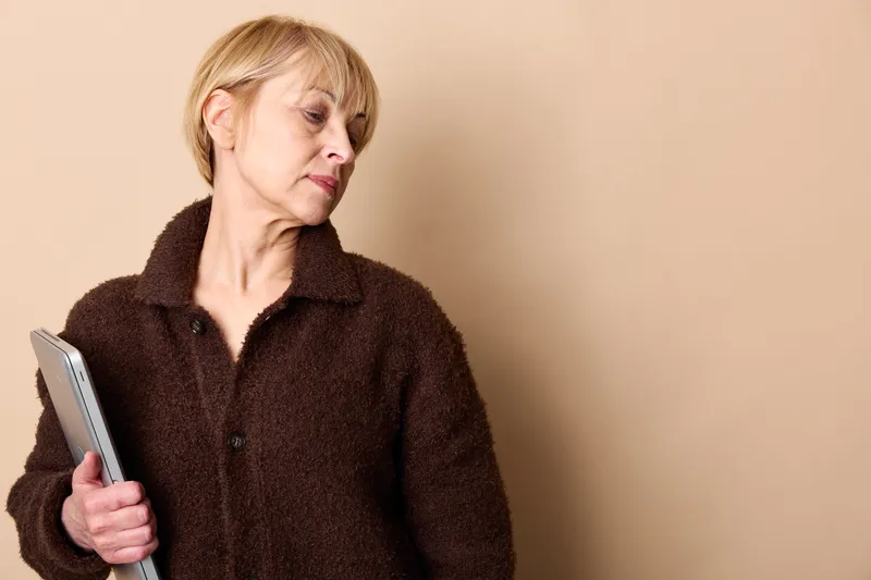 elderly woman smartphone shows stress and tired concerned expression, eyes closed, hand near face, suggests loneliness during communication, isolated mood